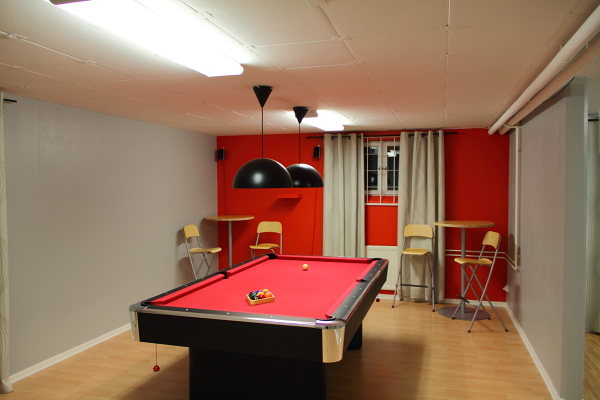 The recreation room's pool table. Tables and barstools in the corners